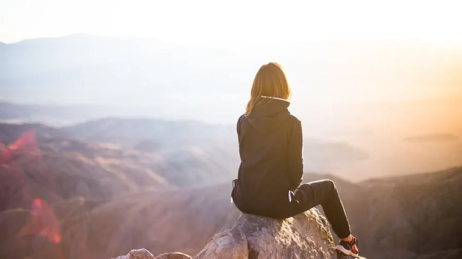 Woman in hoodie enjoying outdoor activities, demonstrating comfortable fit and hood design in real-life setting