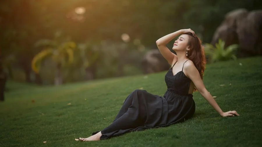 Woman in light cotton summer dress enjoying outdoor warmth and comfort
