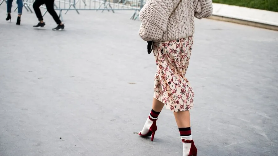 Woman in stylish heels walking outdoors, showing shoe material quality and comfort fit