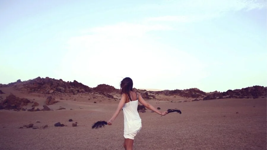 Woman in white tank top styled with sheer layering for versatile outfit demonstration