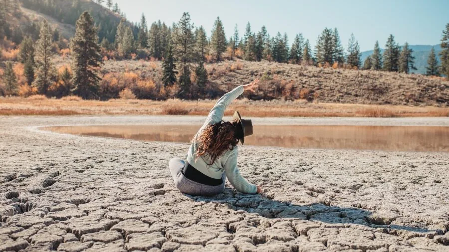Woman in yoga studio using two blocks for symmetrical alignment during triangle pose practice