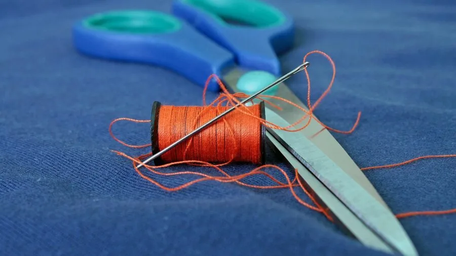 Woman inspecting clothing seams and stitching details up close