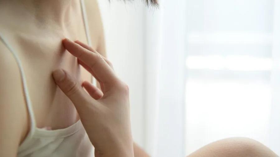 Woman inspecting her hands and cuticles, checking skin sensitivity and condition