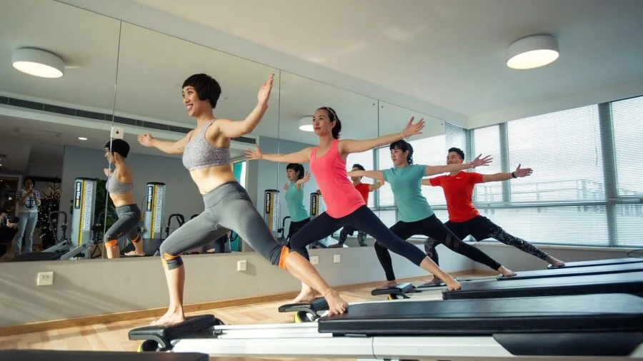 Woman measuring pilates ring size during home workout setup