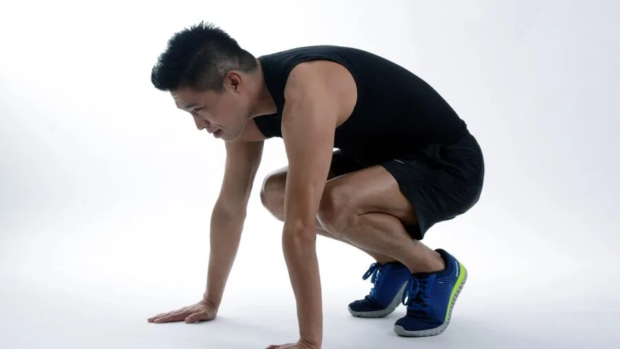 Woman performing a squat during fitness workout to test legging opacity and quality