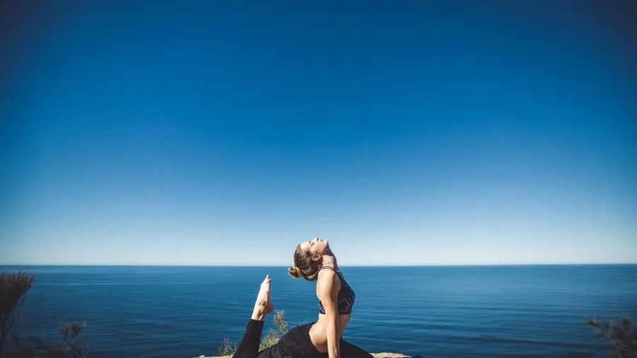 Woman performing overhead yoga stretch demonstrating flexibility and range of motion during workout