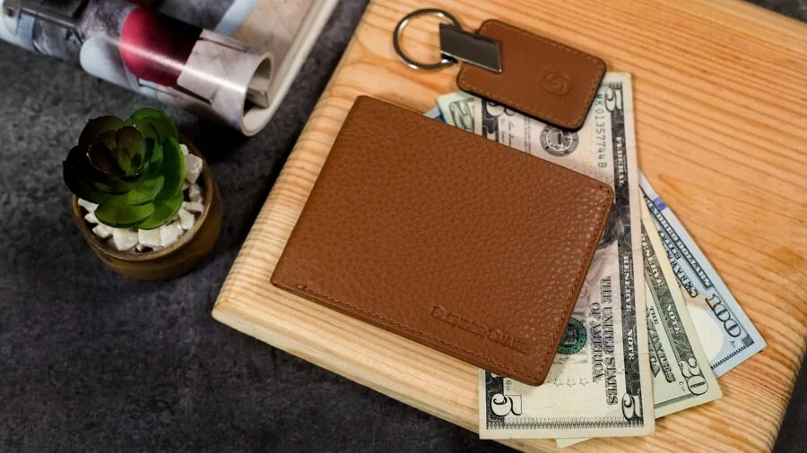 Woman placing slim bifold wallet into jacket pocket