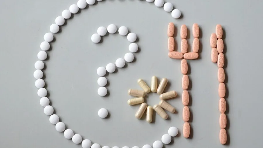 Woman reviewing health supplement costs and budget planning at home desk