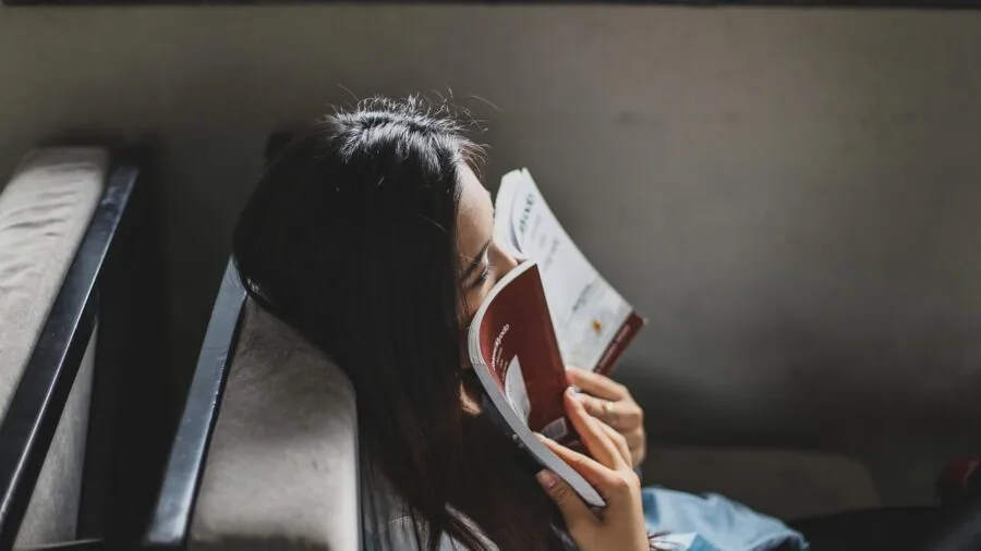 Woman sitting comfortably while reading, representing confidence and ease during menstruation