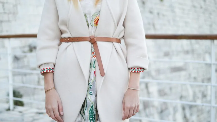 Woman styling versatile cocktail outfit with different shoes and accessories for multiple occasions