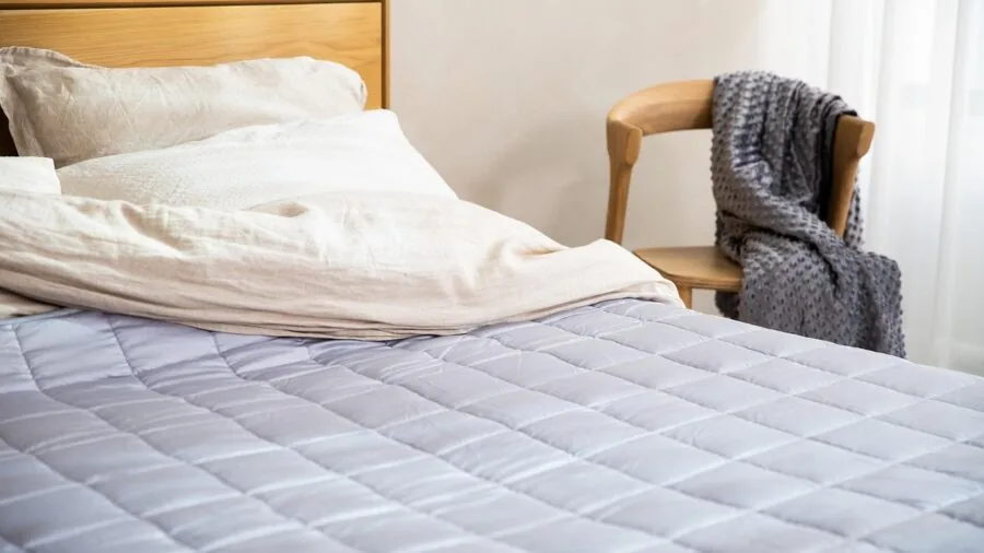 Woman testing mattress comfort during in-home trial period