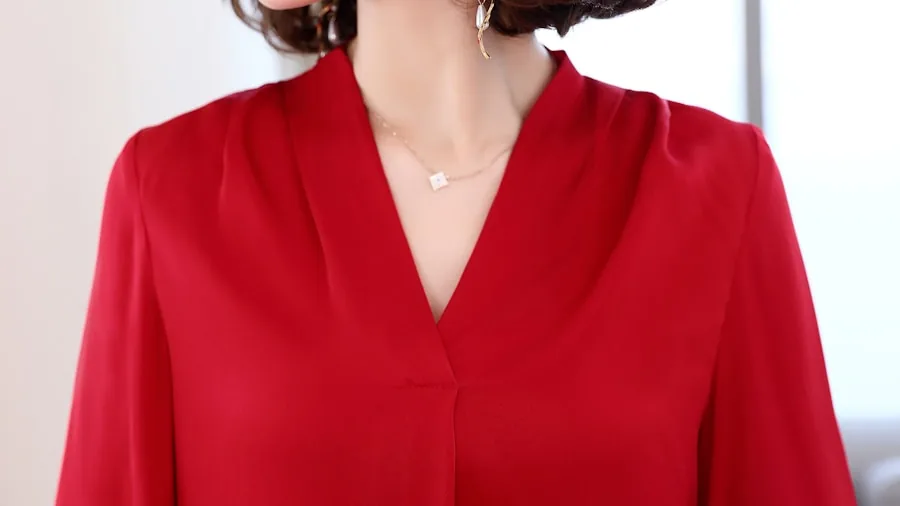 Woman wearing an elegant midi-length dress at an evening event, showcasing cocktail dress silhouette and length