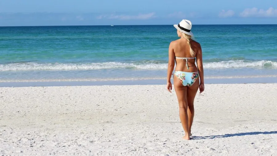 Woman wearing casual cover-up at beachside resort enjoying vacation lifestyle