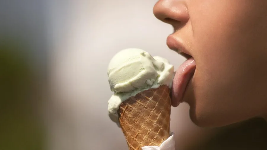 Woman with disgusted facial expression reacting to unpleasant taste or smell