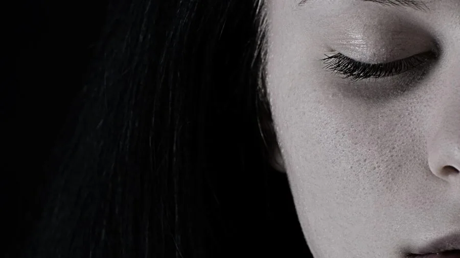 Woman with natural skin texture in natural light showing different skin finishes and radiance