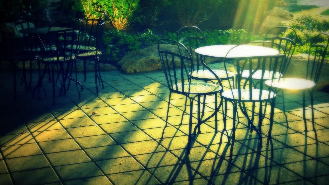 Wooden Adirondack chairs on outdoor patio deck with natural lighting