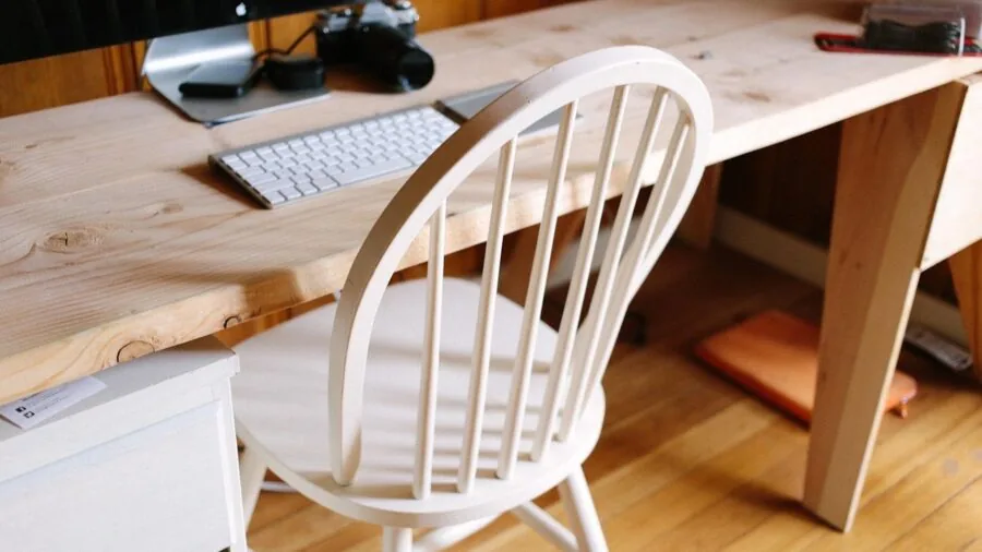 Wooden desk in farmhouse bedroom with natural lighting and home decor