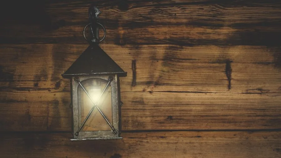Wooden lamp base on table with warm ambient lighting in cozy home interior setting