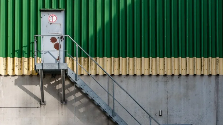 Worker in industrial facility checking air quality and ventilation systems for optimal filtration and clean air circulation