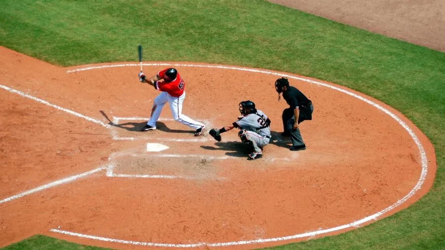 Young baseball player in batting stance during practice on field with natural lighting