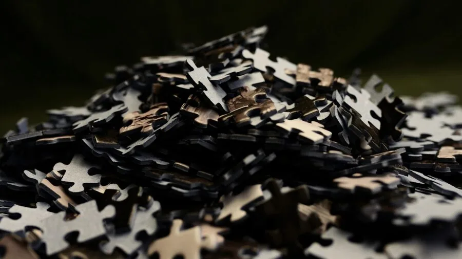 Young child assembling colorful floor puzzle pieces on living room carpet during playtime