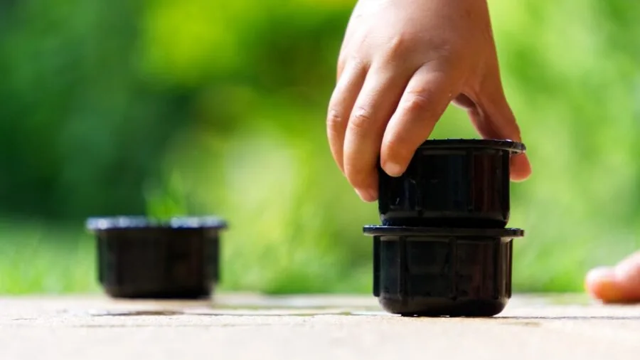 Young child carefully stacking colorful building blocks, concentrating on structure stability and balance