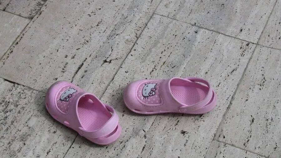 Young child comfortably walking in supportive sandals on outdoor path