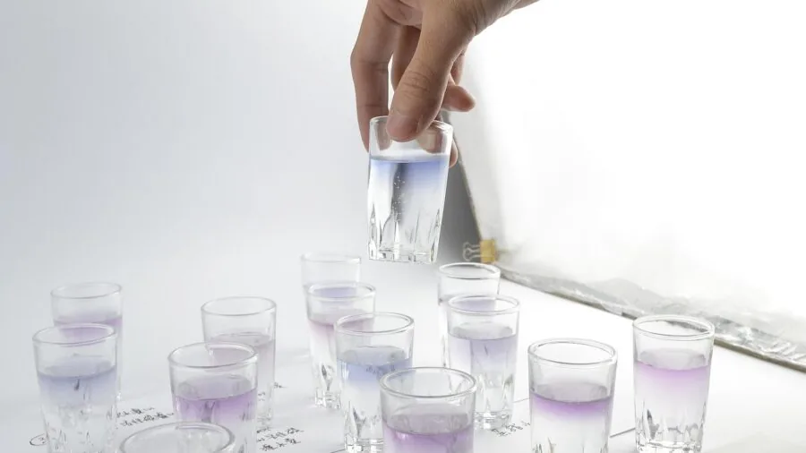 Young child conducting a hands-on science experiment with reusable materials and equipment at home