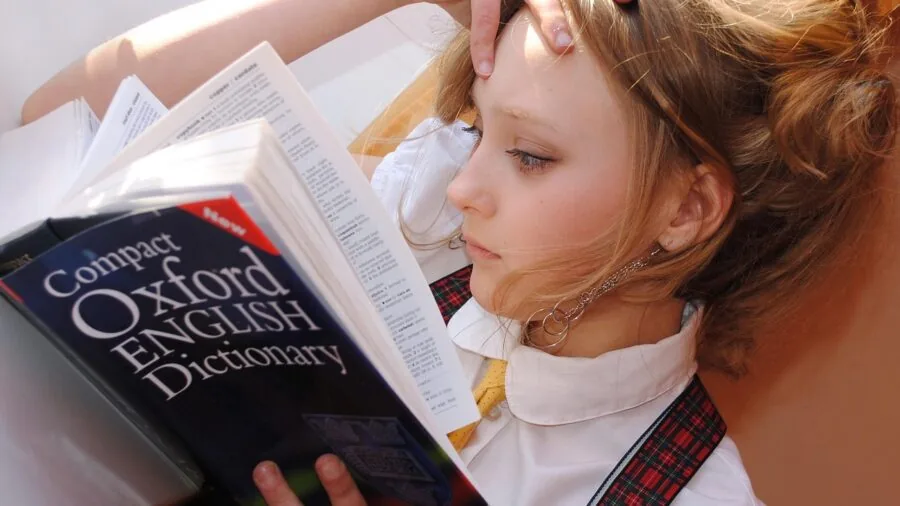 Young child engaged in bilingual learning with parent in natural home setting
