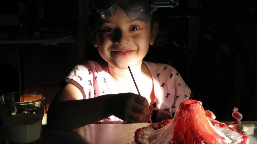 Young child engaged in hands-on science experiment with focused curiosity and wonder