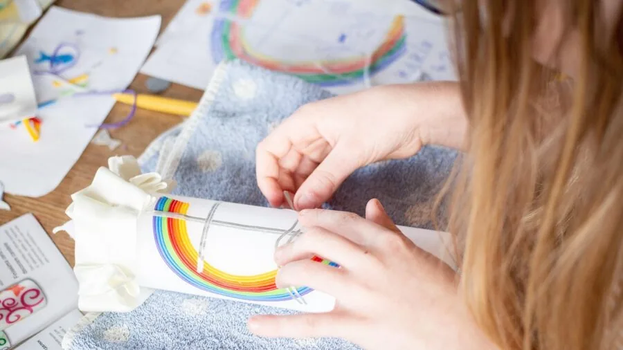 Young child engaged in safe craft activity at home with natural materials