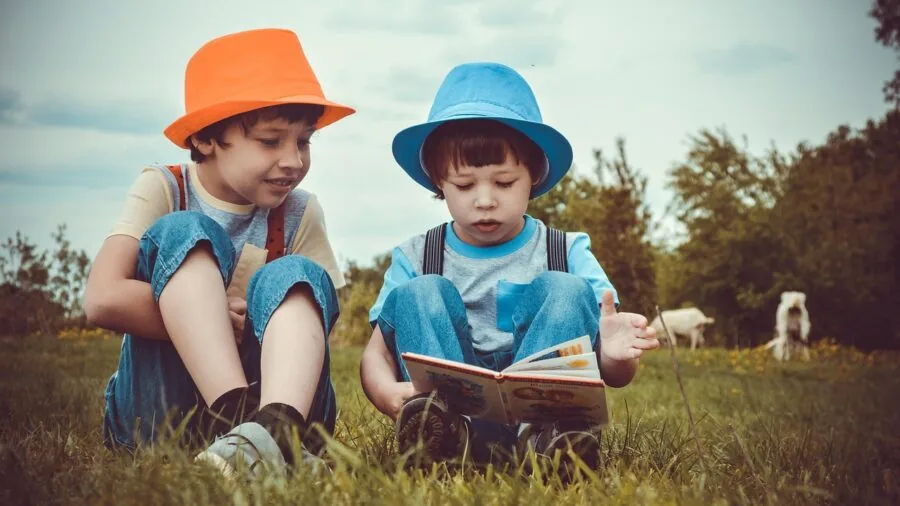 Young child engaging with interactive learning book while sitting comfortably, exploring educational content