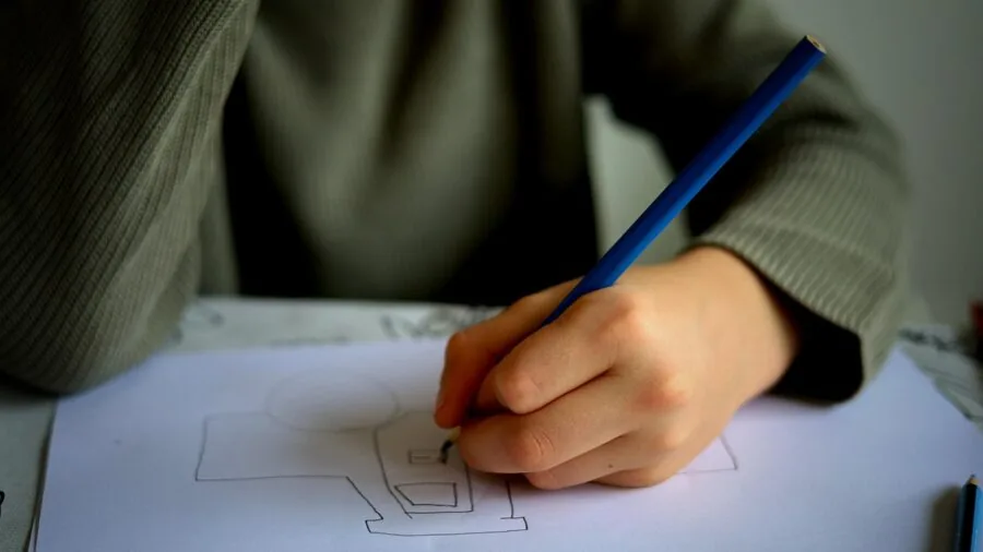 Young child enjoying a coloring activity while traveling in a car or vehicle