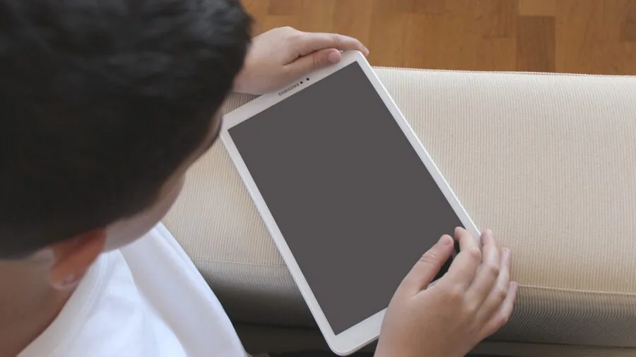 Young child enjoying interactive digital entertainment on a touchscreen device