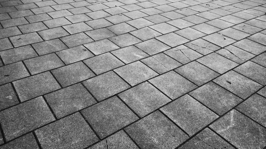 Young child enjoying outdoor play on a paved surface during daytime