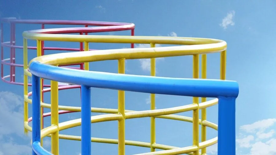 Young child enjoying outdoor playground slide on sunny day in park setting