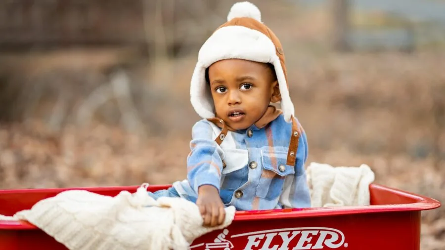 Young child enjoying outdoor playtime in a sunny park setting with natural scenery