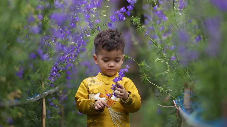 Young child enjoying water play outdoors in summer, demonstrating safe water activities for toddlers