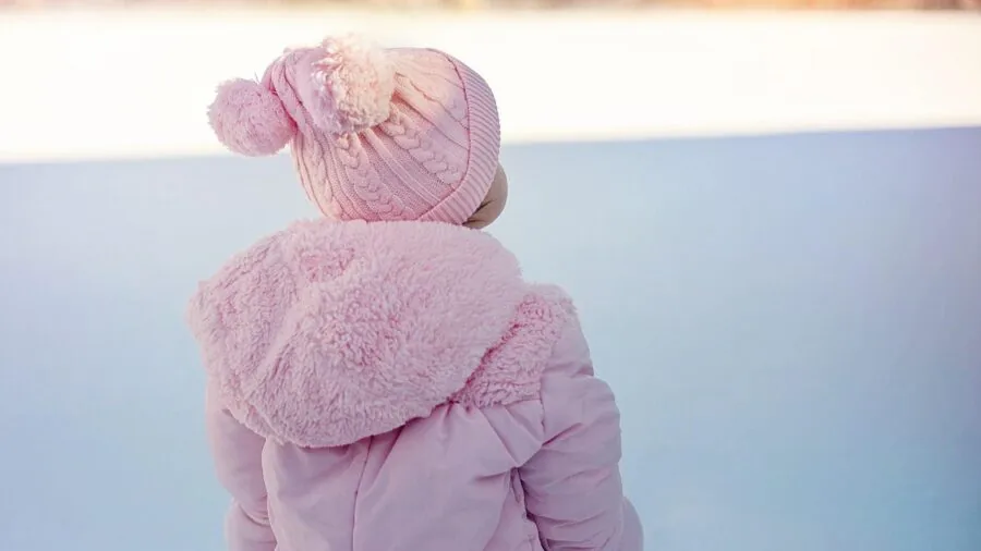 Young child enjoying winter play in snowy outdoor environment