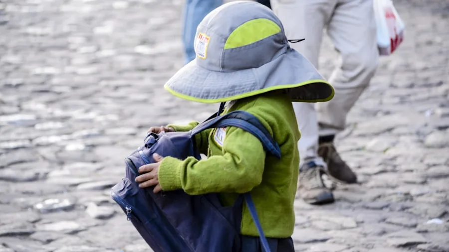 Young child excited about their colorful backpack during morning routine