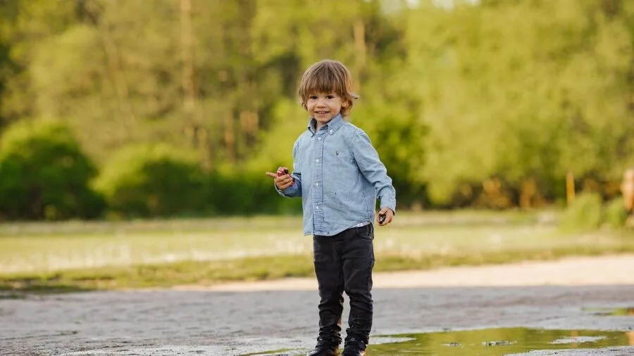 Young child happily playing with a colorful floor puzzle, focused and motivated during playtime