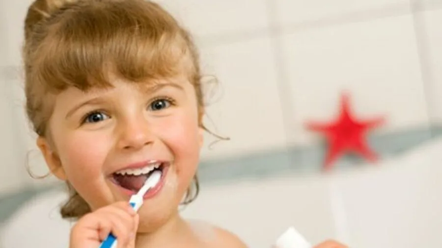 Young child in bathroom learning to use toilet with parent guidance and support
