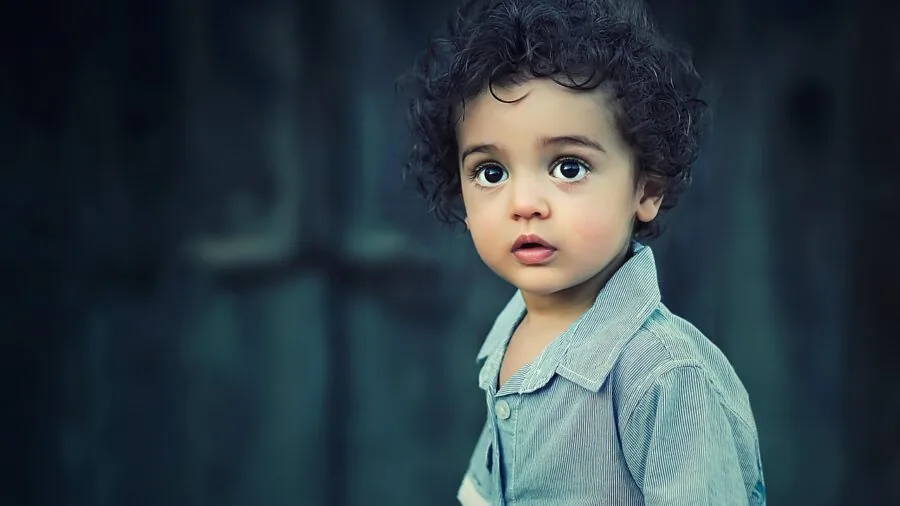 Young child in comfortable cotton t-shirt playing outdoors on grass