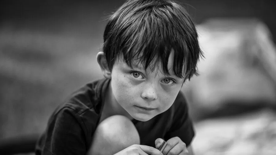 Young child in white t-shirt playing outdoors, demonstrating versatile basics for everyday wear