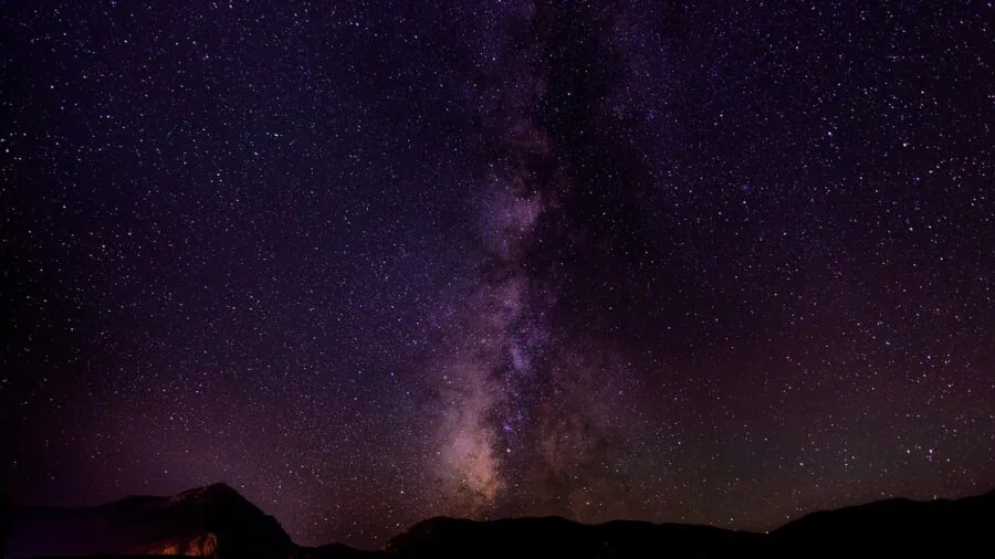 Young child looking up at stars in night sky with sense of wonder and curiosity