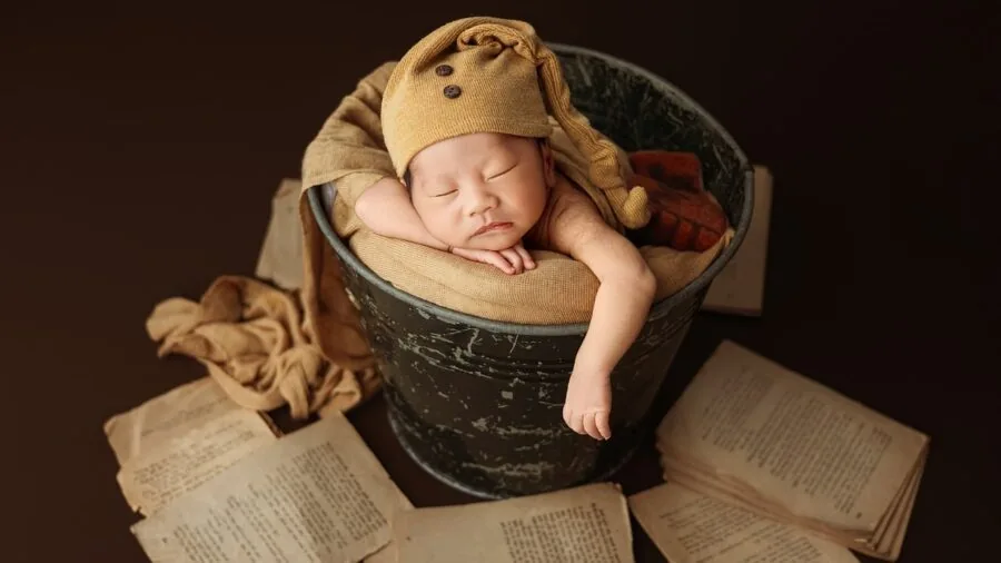 Young child peacefully sleeping in a cozy, colorfully decorated bedroom with themed wall decorations and soft lighting