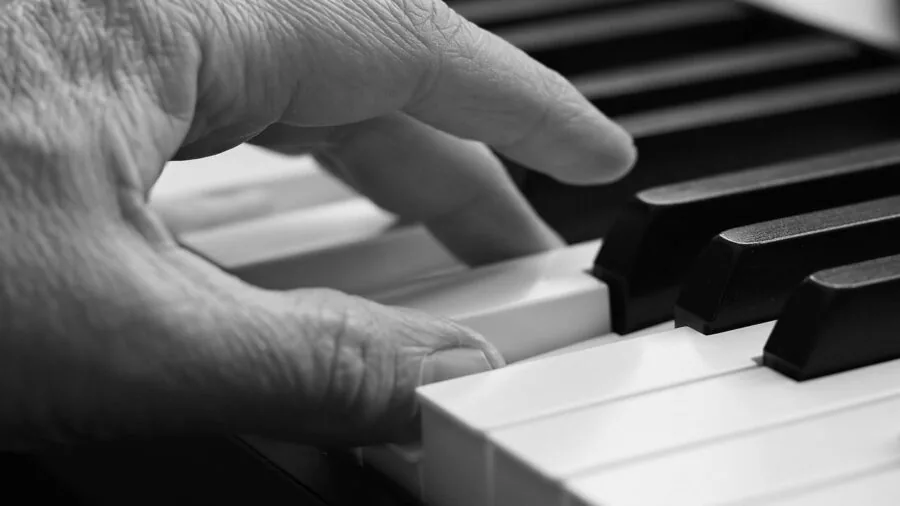 Young child playing electronic keyboard at home in casual setting