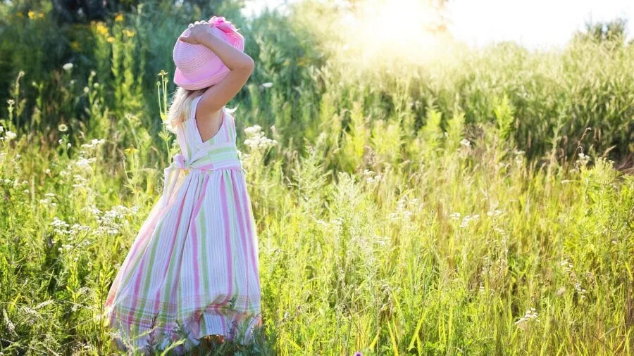 Young child practicing putting on shoes by themselves, developing self-dressing skills