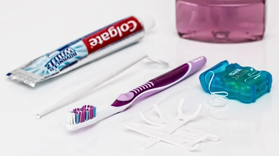 Young child practicing sustainable dental hygiene with natural toothbrush in bathroom