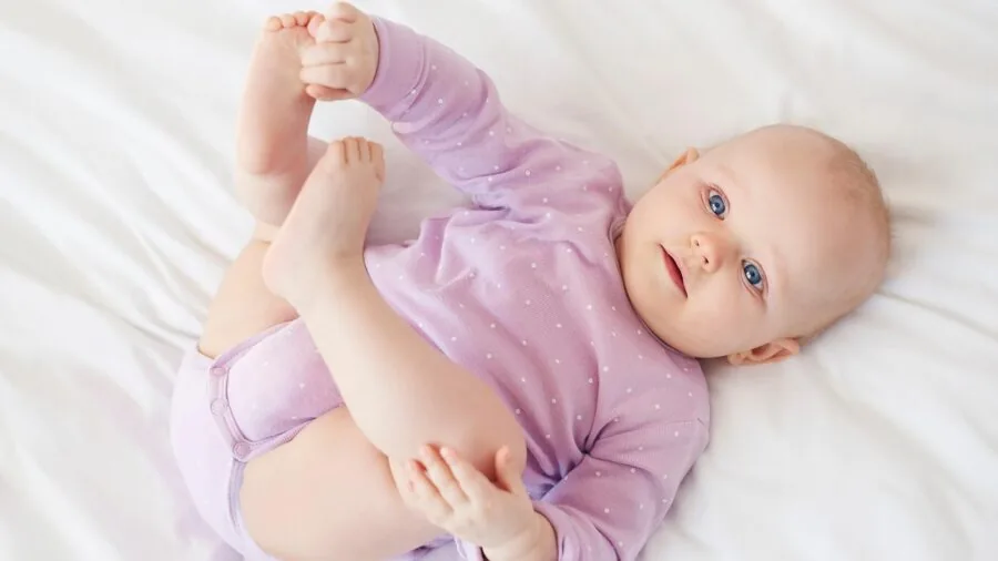 Young child reaching up stretching, showing natural growth and development progression